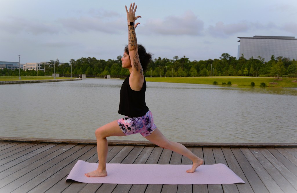 Carola doing a high lunge by the lake 