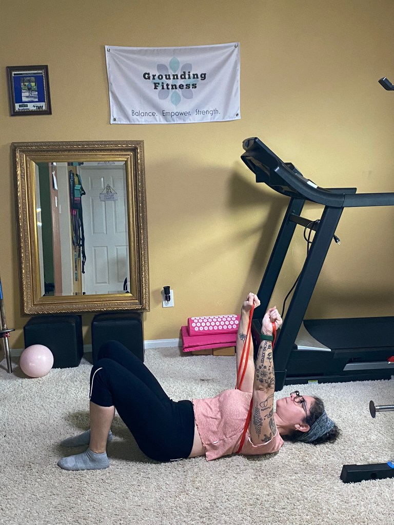 Carola performing a Chest press with band