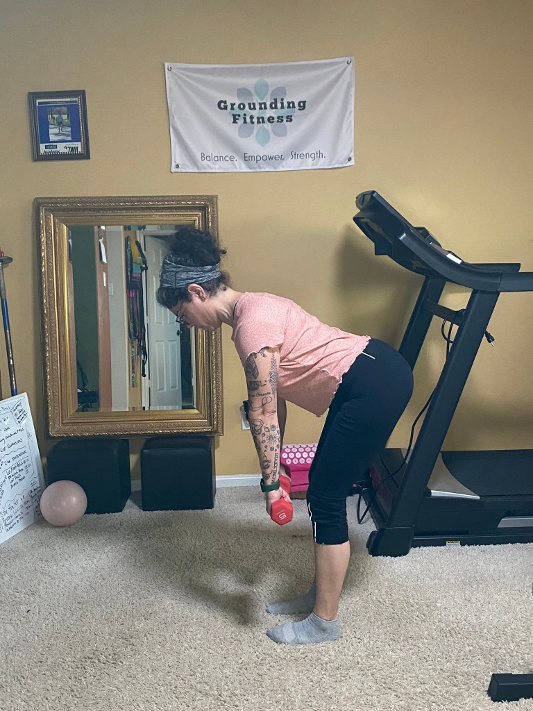 Carola performing a Deadlift with weights