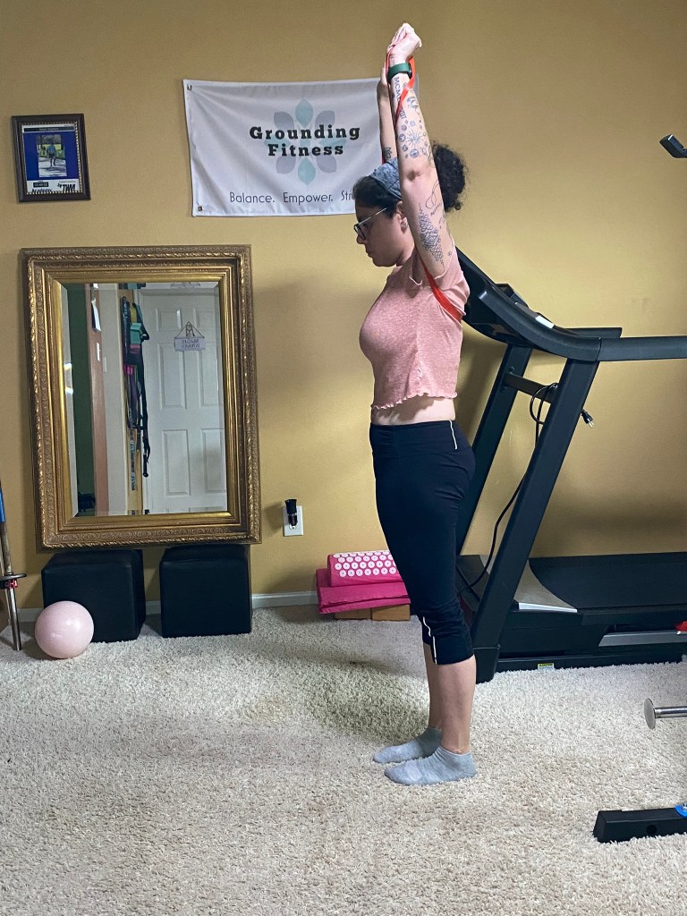 Carola performing a Overhead press with band