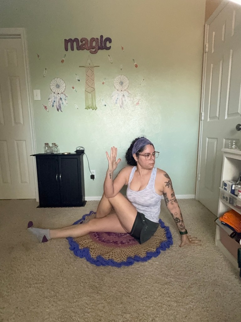 Girl doing Spinal twist showing elongated spine.