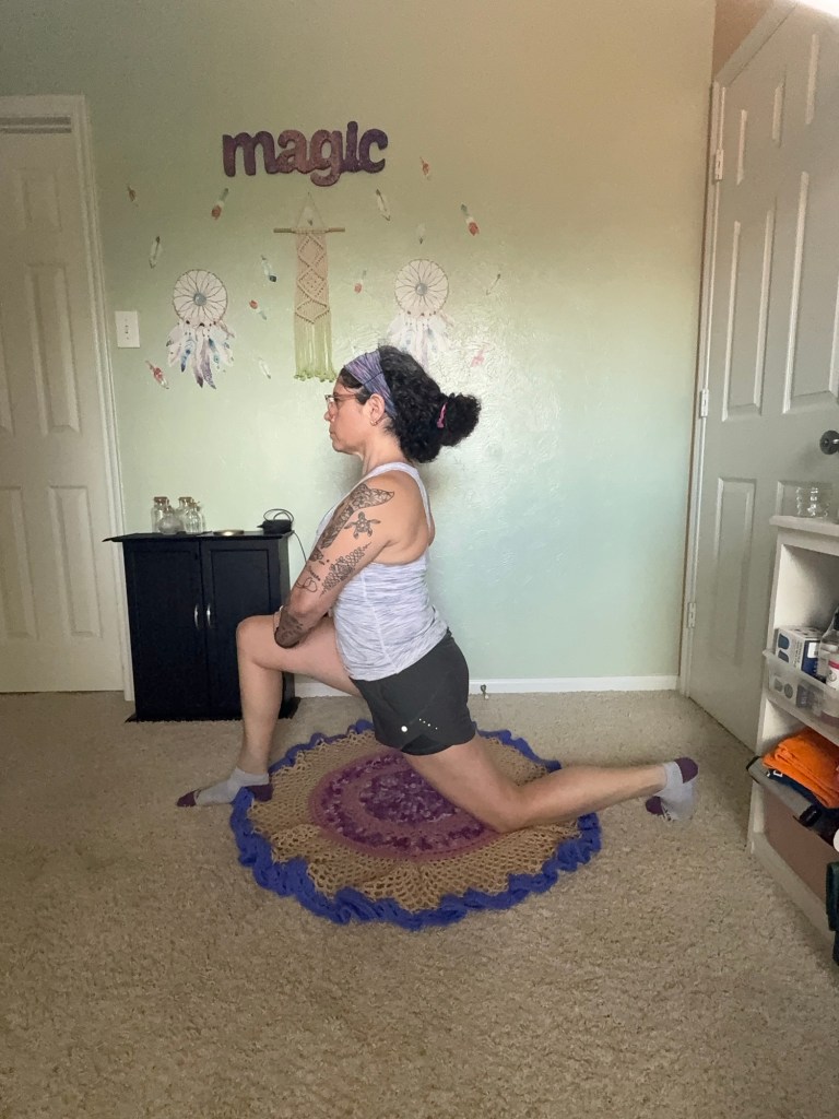 Girl lunging forward with knee on the floor and spine upright.