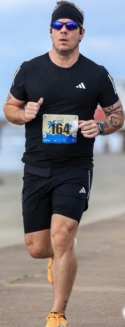 Man running by the beach.