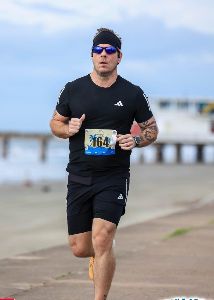 Robert running along the Seawall in Galveston, TX